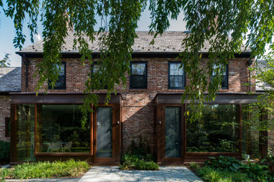Inspiration for a large modern three-storey brick house exterior in Philadelphia with a gable roof and a shingle roof.