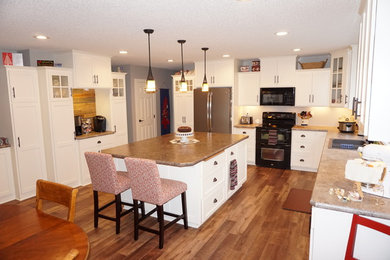Inspiration for a large cottage u-shaped vinyl floor eat-in kitchen remodel in Minneapolis with a drop-in sink, recessed-panel cabinets, white cabinets, laminate countertops and an island
