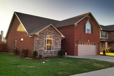Mid-sized elegant red one-story exterior home photo in Nashville with a shingle roof