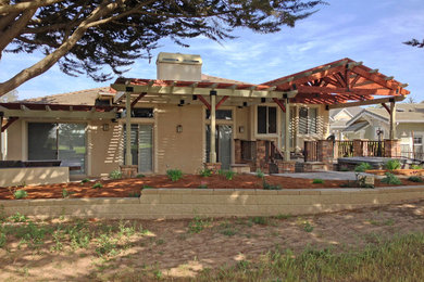 Mid-sized elegant backyard stone patio kitchen photo in San Luis Obispo with a pergola