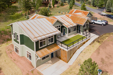 Country green one-story concrete fiberboard exterior home idea in Denver with a metal roof