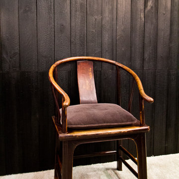 Shou Sugi Ban Charred wall cladding with antique chair