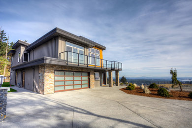 Huge modern gray two-story mixed siding exterior home idea in Other