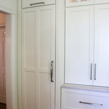 White Kitchen with Gray Quartz Countertops, Farmhouse Sink and Hardwood Floors
