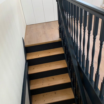 Stripped and painted stairs leading into the loft space.