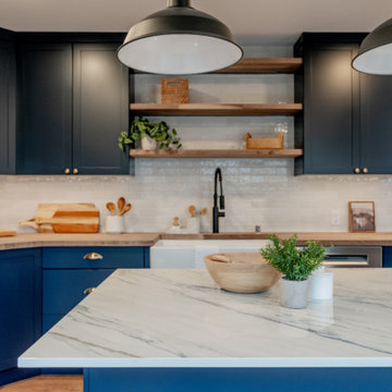 Industrial Matte Black Pendant Lighting over Navy Kitchen Island