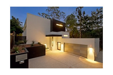 Design ideas for a large modern three-storey concrete multi-coloured house exterior in Brisbane with a flat roof.