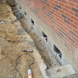 Foundation repair, retrofit by placing rebar and concrete in cores of block - Products