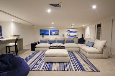 This is an example of a beach style family room in Brisbane.