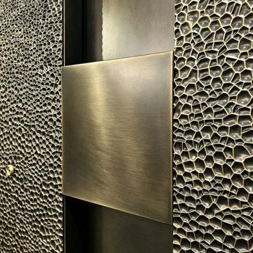 Textured Metal Pivot Door Close-Up