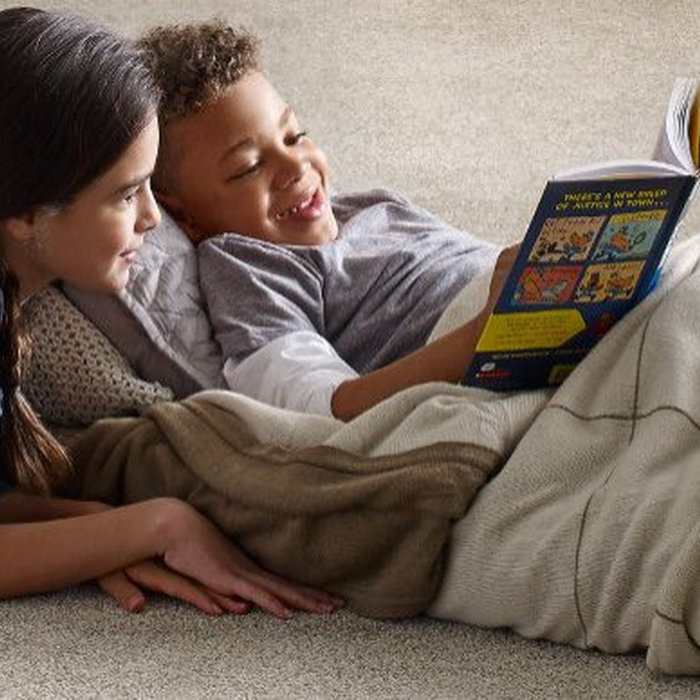 kids reading on rug floor