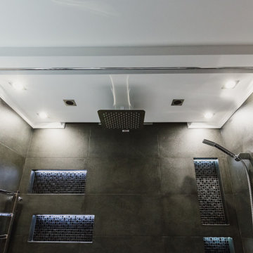 Trendy bathroom in dark color with LED lighting and sound system