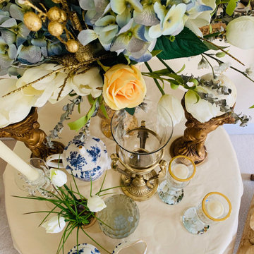 Formal blue and white tablescape features vintage antiques.