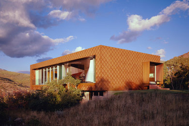 Mid-sized contemporary brown exterior in Salt Lake City with metal siding and a flat roof.