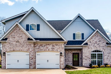 Example of a multicolored two-story brick exterior home design in Other with a shingle roof
