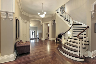 Mid-sized traditional wood curved staircase in Dallas with painted wood risers.