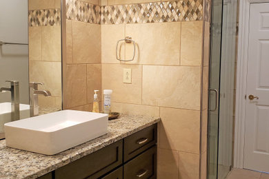 Bathroom - large traditional kids' beige tile and porcelain tile porcelain tile, beige floor and single-sink bathroom idea in Nashville with shaker cabinets, dark wood cabinets, a two-piece toilet, beige walls, a vessel sink, granite countertops, multicolored countertops and a built-in vanity