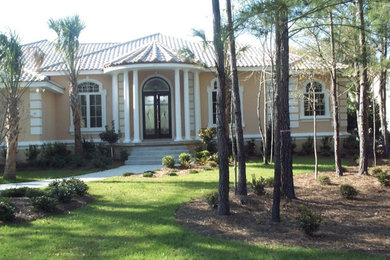 Large mediterranean one-story stucco house exterior idea in Other with a hip roof and a tile roof