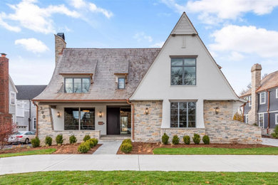 Inspiration for a huge transitional white three-story stone and clapboard house exterior remodel in Chicago with a shed roof, a mixed material roof and a brown roof