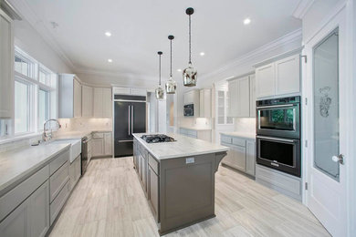 Photo of a country separate kitchen in Minneapolis with white cabinets, black appliances and with island.