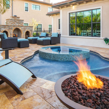 Custom Pool with Spa, Sun Shelf, and Pebble Tec Finish in Parkland Fla.