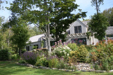 Inspiration for a large rustic partial sun backyard mulch landscaping in New York.