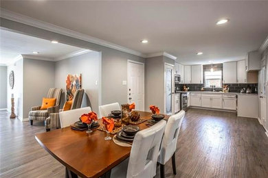Kitchen/dining room combo - mid-sized traditional dark wood floor and brown floor kitchen/dining room combo idea in Dallas with gray walls and no fireplace