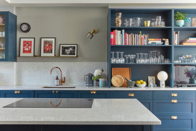 Inspiration for a victorian kitchen in London with a submerged sink, open cabinets, blue cabinets, white splashback, medium hardwood flooring, an island and white worktops.