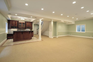 This is an example of a mid-sized traditional look-out basement in Sacramento with green walls, carpet and beige floor.