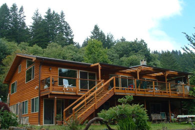 Inspiration for a large rustic brown two-story wood gable roof remodel in Other