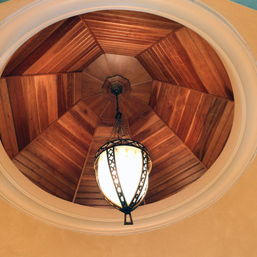 8 sided hand crafted wooden ceiling above a wooden spiral staircase