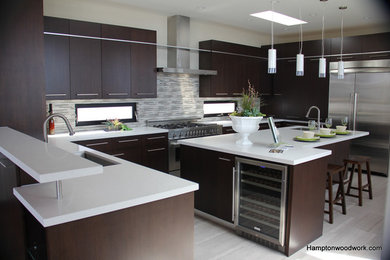 Inspiration for a large contemporary u-shaped open plan kitchen in Los Angeles with an undermount sink, flat-panel cabinets, dark wood cabinets, quartz benchtops, multi-coloured splashback, matchstick tile splashback, stainless steel appliances, medium hardwood floors, with island and brown floor.