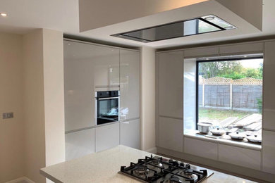 Floor to ceiling bank of kitchen units and integrated appliances