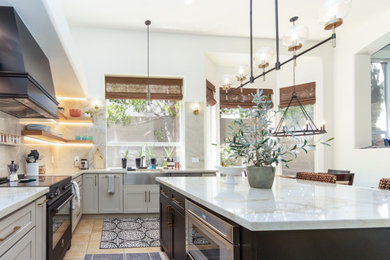Inspiration for a large transitional u-shaped eat-in kitchen remodel in Phoenix with recessed-panel cabinets, white cabinets, beige backsplash, quartz backsplash, black appliances, an island and white countertops