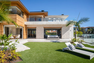This is an example of a large contemporary three-storey multi-coloured house exterior in Los Angeles with mixed siding.