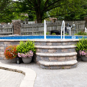 Freeform Semi-inground Stealth with stone steps and landscaping
