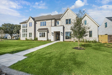 Inspiration for a large transitional beige two-story brick and clapboard exterior home remodel in Houston with a shingle roof and a gray roof