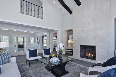 Inspiration for a large transitional open concept medium tone wood floor and brown floor living room remodel in Los Angeles with a standard fireplace, gray walls and a concrete fireplace