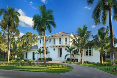 This is an example of a large tropical two-storey stucco white exterior in Miami.