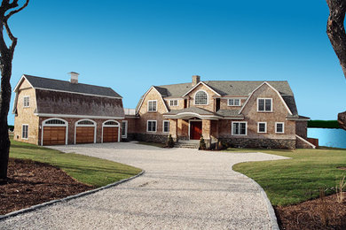 Example of a large cottage brown two-story wood house exterior design in Providence with a gambrel roof and a shingle roof