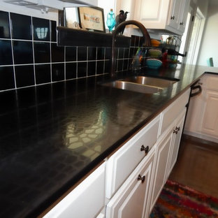 Large contemporary kitchen pantry ideas - Example of a large trendy u-shaped concrete floor kitchen pantry design in Little Rock with an undermount sink, flat-panel cabinets, white cabinets, quartz countertops, black backsplash, ceramic backsplash, black appliances and no island