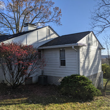 Board and Batton siding on an older brick home