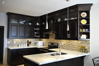 Inspiration for a mid-sized transitional u-shaped eat-in kitchen remodel in Toronto with a double-bowl sink, raised-panel cabinets, dark wood cabinets, quartz countertops, multicolored backsplash, matchstick tile backsplash, stainless steel appliances and a peninsula