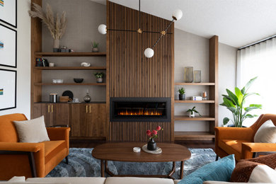 Living room - small mid-century modern enclosed wallpaper, dark wood floor and brown floor living room idea in Calgary with a standard fireplace, a wood fireplace surround, white walls and no tv