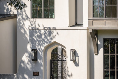 Inspiration for a transitional white house exterior remodel in Dallas with a black roof