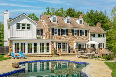 Inspiration for a huge country backyard stone patio remodel in Philadelphia with no cover