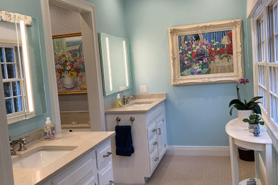 Inspiration for a mid-sized timeless master beige tile and ceramic tile double-sink, porcelain tile, beige floor and wallpaper bathroom remodel in Chicago with raised-panel cabinets, white cabinets, an undermount tub, quartz countertops, beige countertops, a freestanding vanity, blue walls and an undermount sink