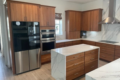 Inspiration for a mid-sized 1960s u-shaped light wood floor open concept kitchen remodel in Orlando with an undermount sink, flat-panel cabinets, medium tone wood cabinets, quartz countertops, white backsplash, quartz backsplash, stainless steel appliances, an island and white countertops
