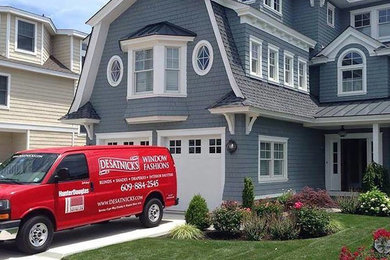 Inspiration for a large timeless blue three-story wood exterior home remodel in Philadelphia