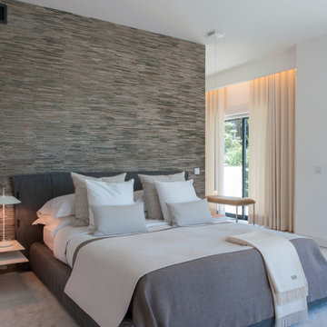 Main Suite with Grey Bed and Stone Wall, Paço de Arcos
